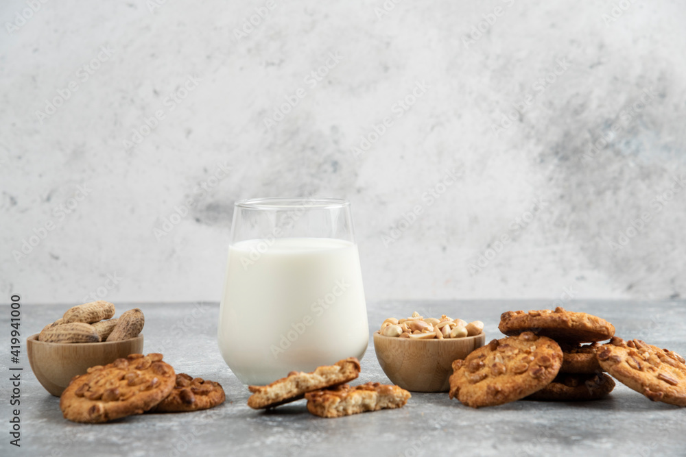Cookies with organic peanuts and honey with glass of milk on marble background Cookies with organic peanuts and honey with glass of milk on marble background