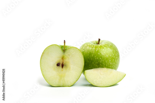 Whole and sliced green apples isolated on white background
