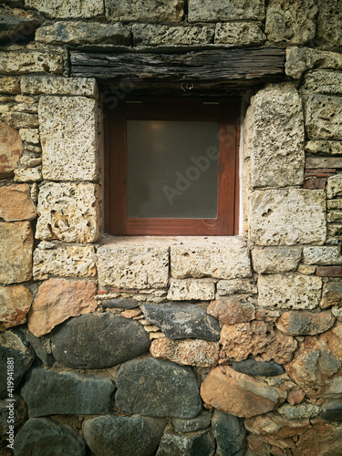 closed window in a brick wall. Textured gray wall