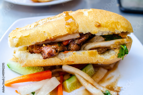 Baguette and grilled meatballs in Cambodia gravy style with sauce Called : Nom pang Num pang photo