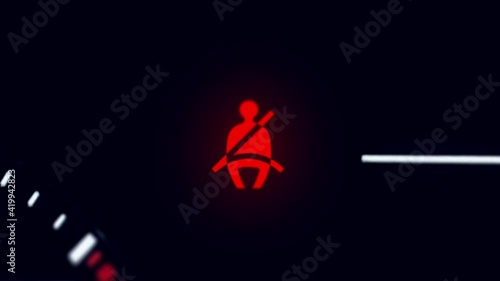 Super macro shot of red seatbelt warning sign blinking on instrument panel dashboard of the generic car