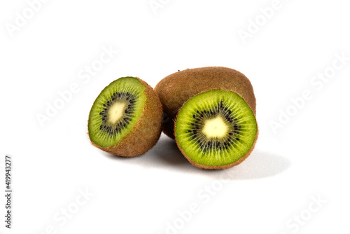 Whole kiwi fruits and half kiwi fruits on a white background