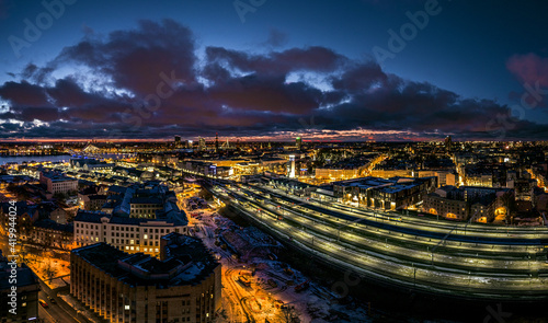 Riga central station at night time. Rail Baltica project modernizing railroad infrastructure. Shopping mall Origo. 