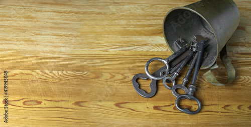 Old keys in a metal mug