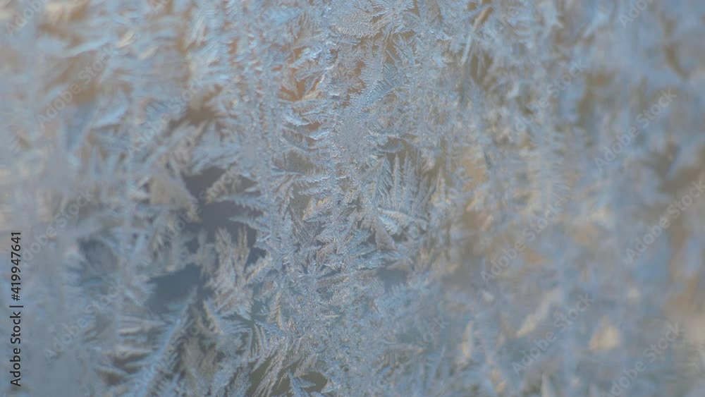 Frosty ice flowers on a window, ice crystal in macro