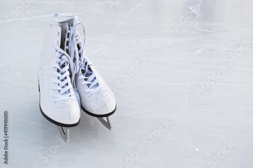 Skates lie on the ice. Winter entertainment ice rink. A copy of the space.
