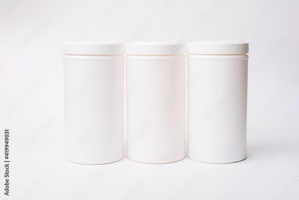 Photo of three white containers mockup over white background Photo of three white containers mockup over white background