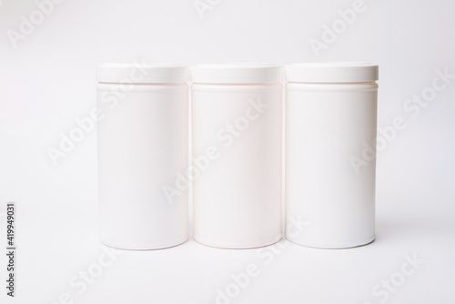 Photo of three white containers mockup over white background