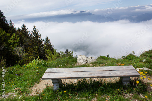 Bench with foggy alpes mountain spring panorama view from Mont Revard belvedere Auvergne-Rhône-Alpes region France Europe