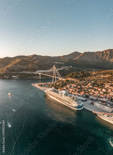 Aerial drone shot of cruise ship at Port Gruz in dalmatia coastline in Croatia summer sunset