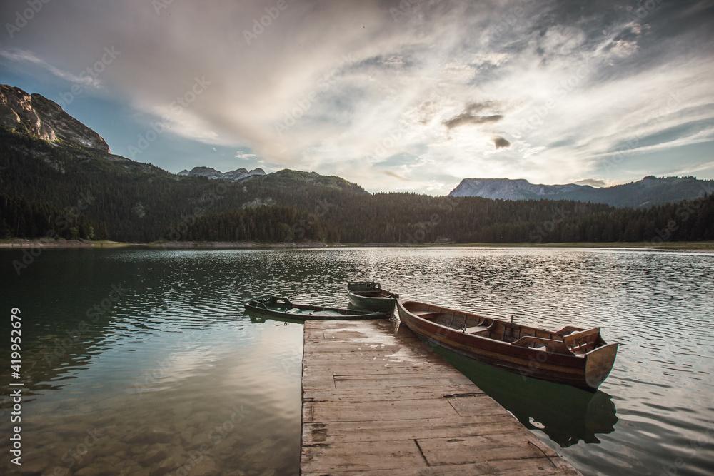 Beautiful mountain lake scenery with boats in the water