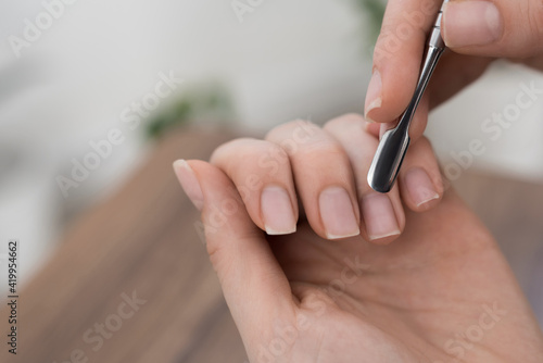 women hands making manicure itself at home