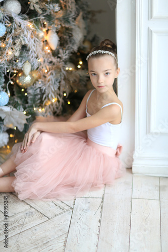 A small ballerina near the Christmas tree. The Nutcracker . New Year's gifts