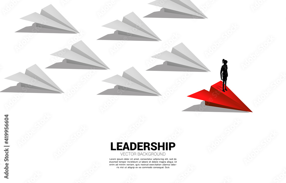 Silhouette of businesswoman standing on red origami paper airplane leading group of white. Business Concept of leadership and vision mission. Silhouette of businesswoman standing on red origami paper airplane leading group of white. Business Concept of leadership and vision mission.