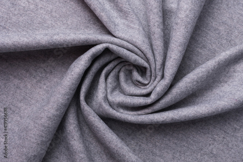 Grey textile and texture concept - close up of crumpled fabric background. Top view