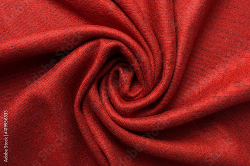 Textile and texture concept - close up of crumpled red fabric background. Dark red color. Top view