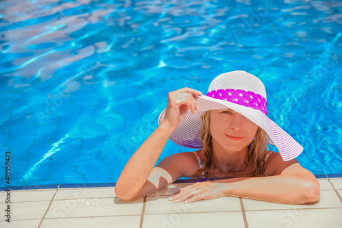 happy girl in a hat by the pool on the nature of the sea shore © Kostia
