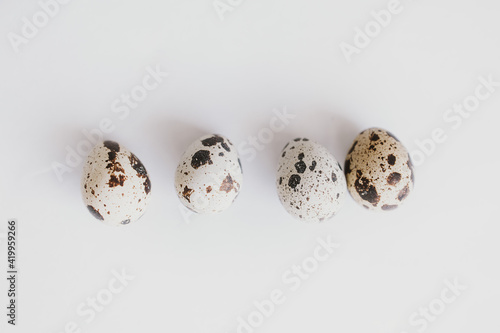 little quail eggs on a light smooth background in close-up