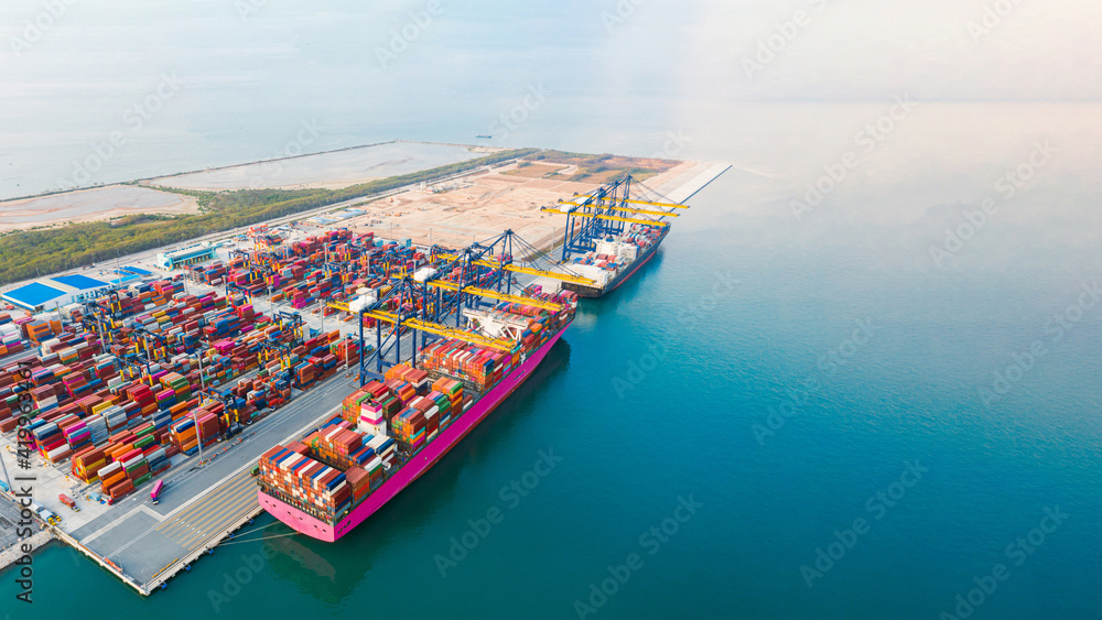 Aerial top view of containers cargo ship. business logistic transportation sea freight, cargo ship, cargo container in deep sea port at industrial estate for import export around in the world