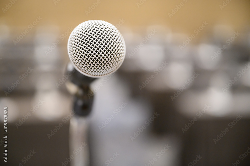 Microphone over the blurred business people forum Meeting Conference Training Learning Coaching Concept, Blurred background. Microphone over the blurred business people forum Meeting Conference Training Learning Coaching Concept, Blurred background.