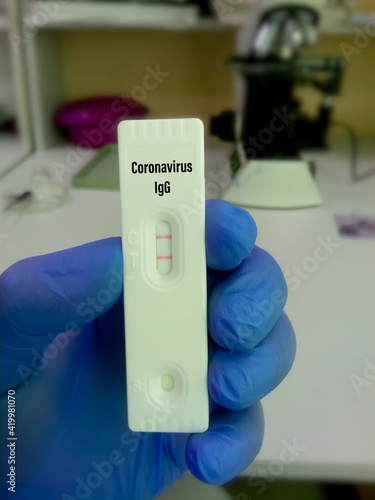 close up view of Technologist or technician glove hand hold a device of Corona virus Antibody Rapid Screening Test. Covid-19