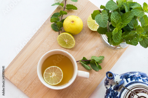 herbal healthy drinks hot tea honey lemon for health care with peppermint leaf and lemon slice for relaxation arrangement flat lay style on background wooden