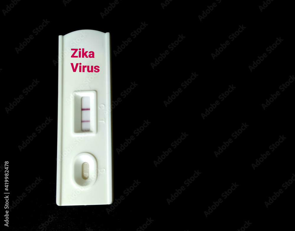 Rapid testing device or cassette for zika virus isolated with black background, showing positive result, copy space Rapid testing device or cassette for zika virus isolated with black background, showing positive result, copy space