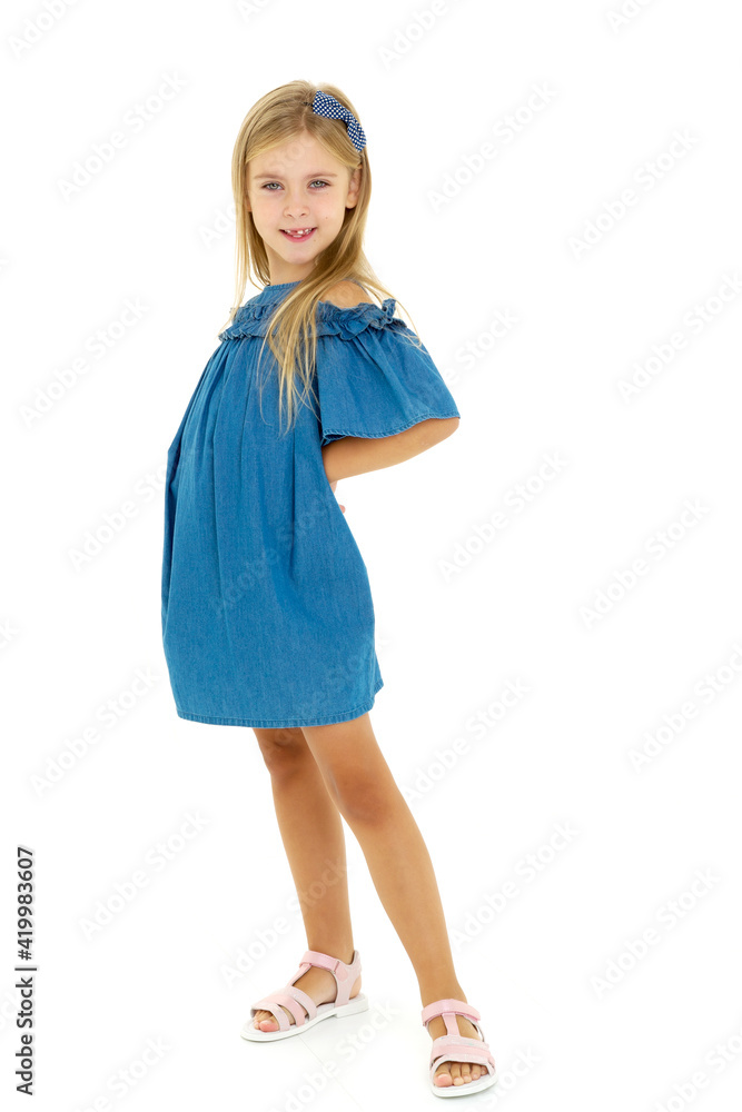 Child girl standing clasped hands behind her back. Child girl standing clasped hands behind her back.