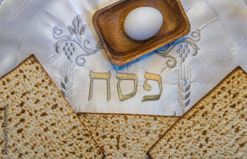 Pesah celebration concept (Jewish Passover holiday). Top view on traditional food attributes. Hebrew letters, in English translation mean as Jewish Passover photo