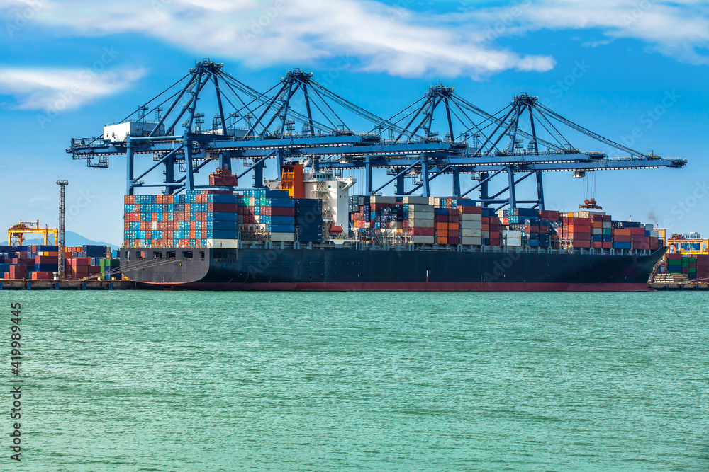 Container Cargo freight ship with working crane loading bridge in shipyard at dusk for Logistic Import Export background Container Cargo freight ship with working crane loading bridge in shipyard at dusk for Logistic Import Export background