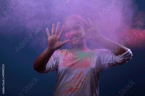 Girl plays with Holi festival colours.Concept for Indian festival Holi