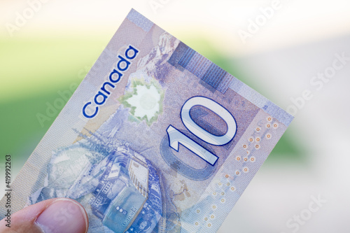 Close up of purple Canadian ten (10) dollar bill with blurred defocused background. Macrophotography. photo