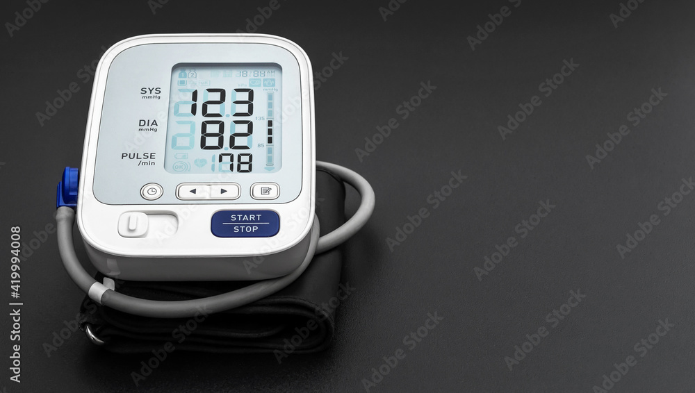 Medical electronic tonometer on black background. Top view. Space for text. Medical electronic tonometer on black background. Top view. Space for text.