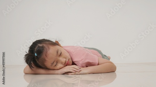 asian girl sleeping, lying on the floor
