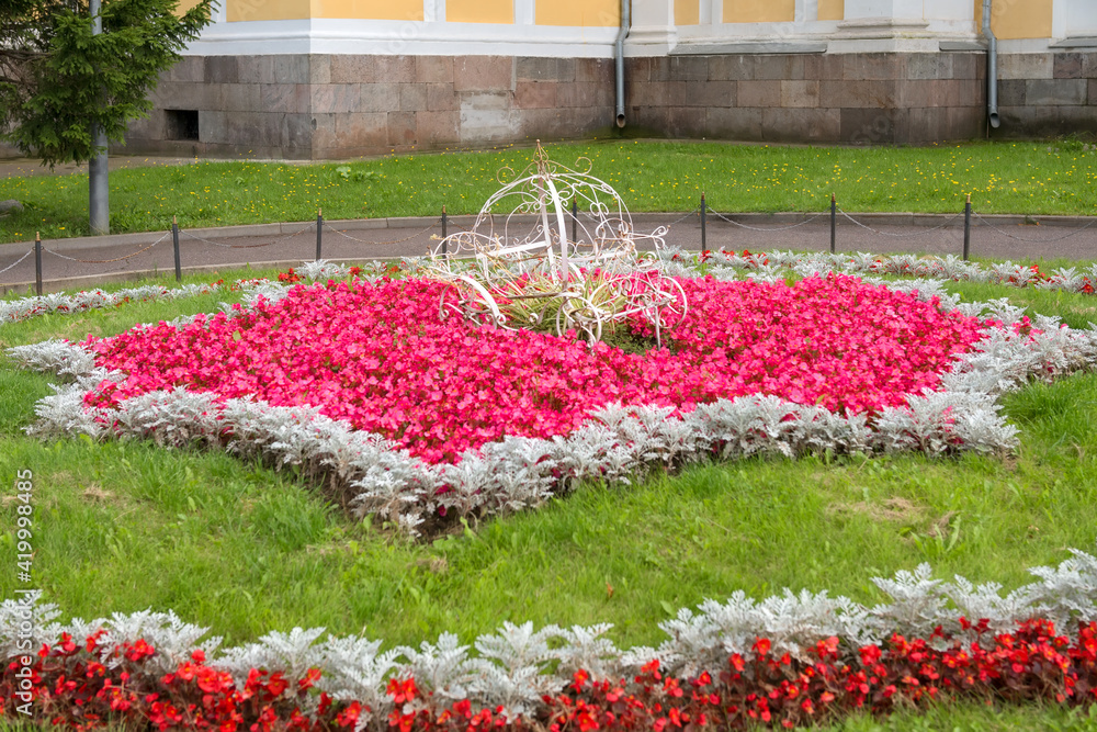 A flower bed and a carriage in the center. Landscape design