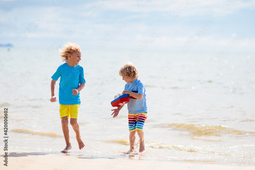 Kids playing on beach. Children play at sea. Kids playing on beach. Children play at sea.