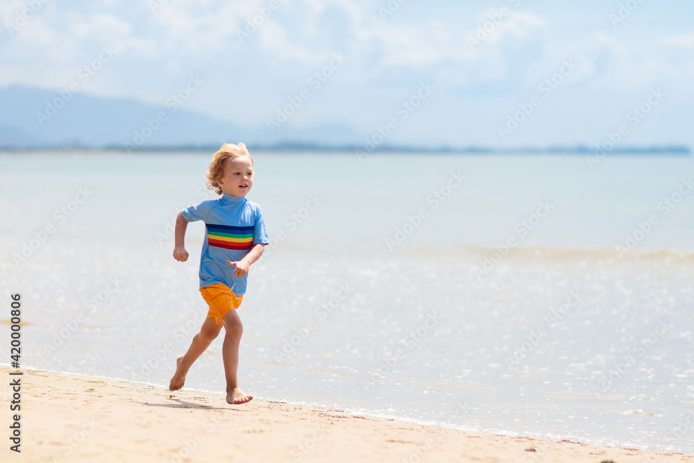 Kids playing on beach. Children play at sea.