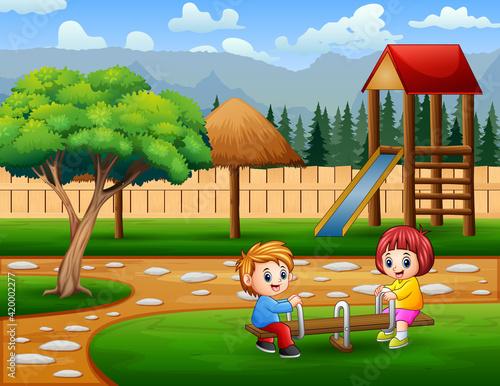 Happy cute boy and girl play seesaw