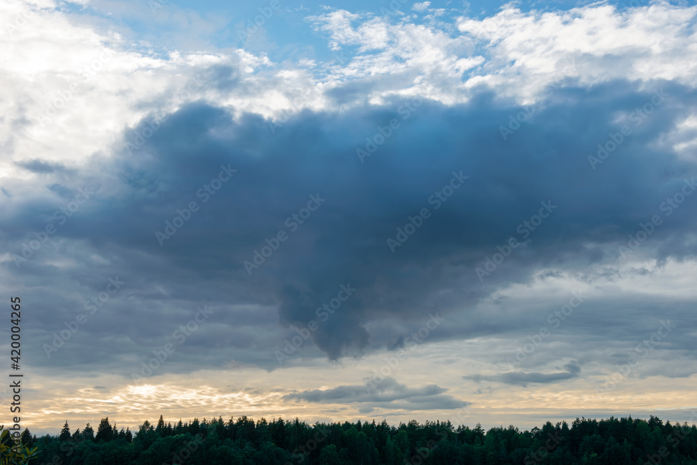 Before the rain. Thundercloud over an agricultural field on a summer evening