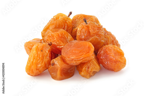 Pile dried tasty yellow plums isolated on white