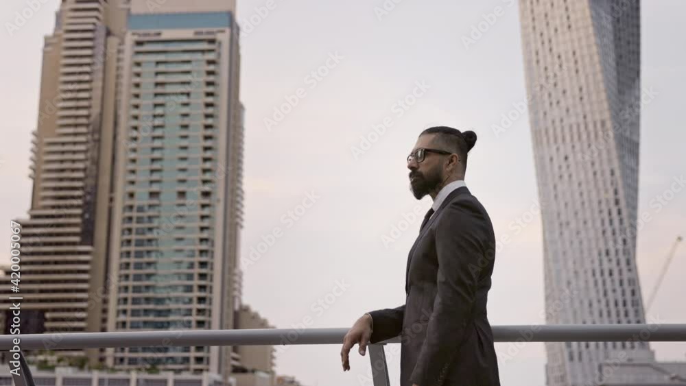 Confident Young Businessman Admires The Scenery Of Dubai. Stylish Man In Black Suit. Confident Young Businessman Admires The Scenery Of Dubai. Stylish Man In Black Suit.