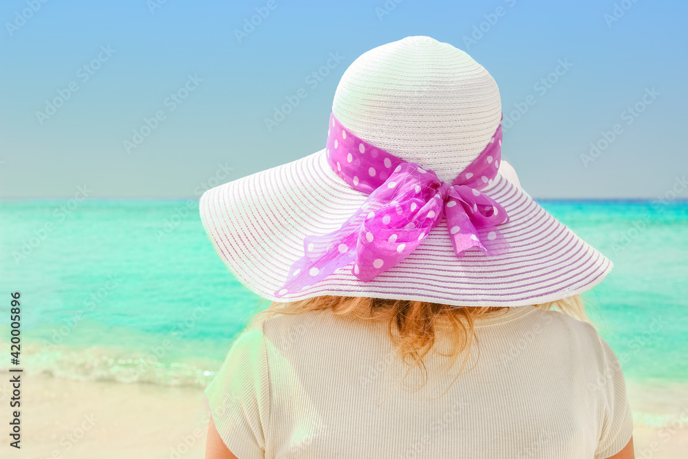 happy girl in hat at the sea shore on the nature of Cyprus