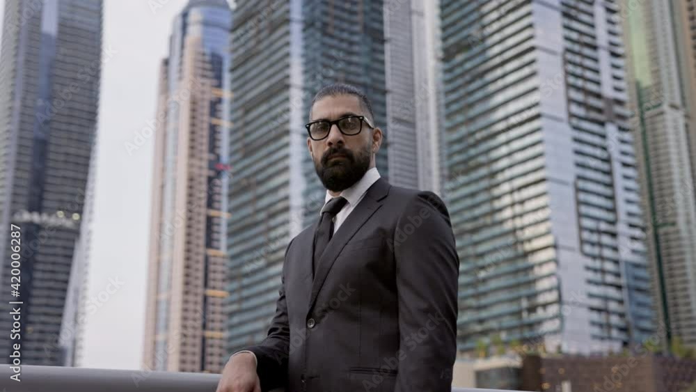 Confident Young Businessman Admires The Scenery Of Dubai. Stylish Man In Black Suit. Confident Young Businessman Admires The Scenery Of Dubai. Stylish Man In Black Suit.