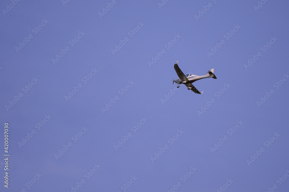 small plane with propellers flying in the blue sky. means of air transport small plane with propellers flying in the blue sky. means of air transport