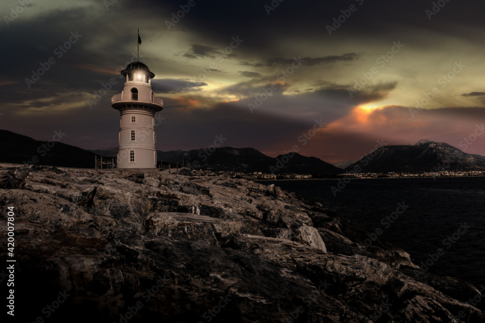 Lighthouse on a mediterranean coast at night.