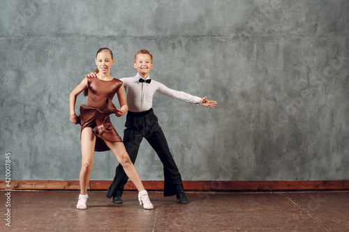 Young dancers boy and girl dancing in ballroom dance Samba © primipil