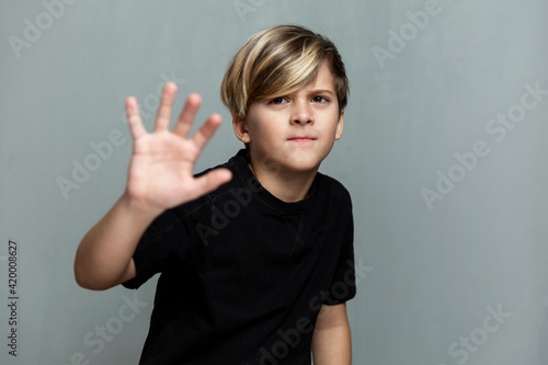 Wallpaper Mural A frightened boy in a black T-shirt. Loneliness, stress and fear. Grey background. Torontodigital.ca