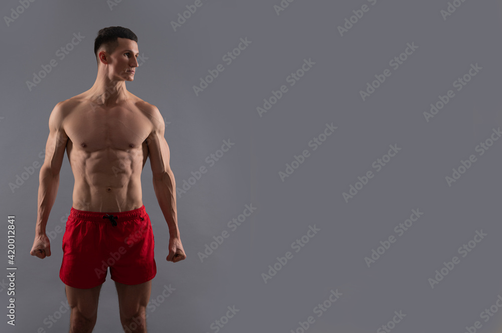 Sport fan. Sportsman with six pack abs. Muscular man grey background. Sport and fitness