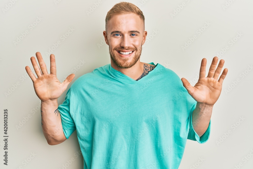 Young caucasian man wearing casual clothes showing and pointing up with fingers number ten while smiling confident and happy. Young caucasian man wearing casual clothes showing and pointing up with fingers number ten while smiling confident and happy.