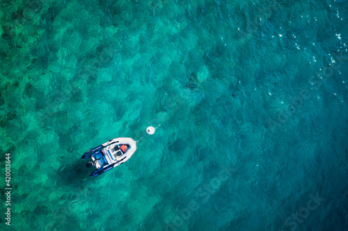 Top view of turquoise water and boat.